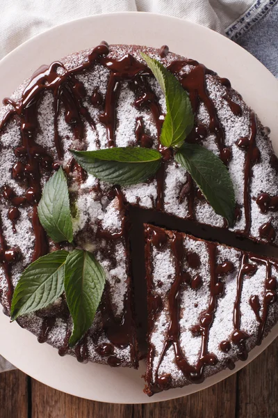 Poppy seed cake with powdered sugar and mint close-up. vertical — Stock Photo, Image