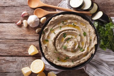 Middle Eastern cuisine: baba ghanoush closeup in a plate. Horizo clipart