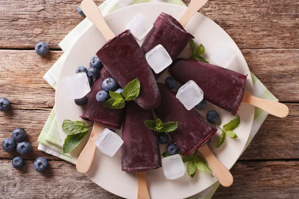 美味的蓝莓果汁冰糕在板上的棍子特写。水平移动 — 图库照片