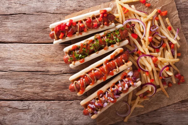 Hot dogs with ketchup, mustard, onions and french fries. horizon — Stock Photo, Image