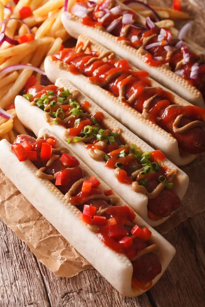 Hot dogs with a variety of stuffings closeup, and french fries o — Stock Photo, Image