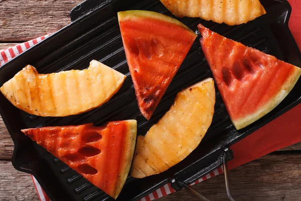 Sliced watermelon and melon in a pan grill closeup. Horizontal t — Stock Photo, Image