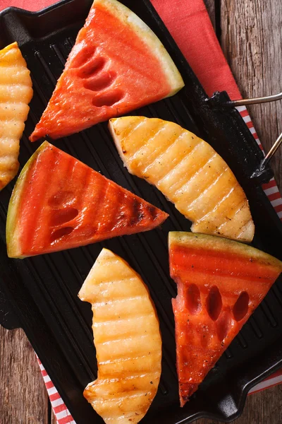 Sliced watermelon and melon in a pan grill closeup. vertical top — Stock Photo, Image