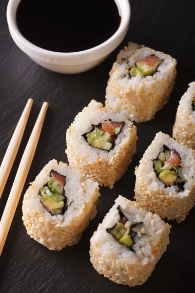 Japanese california roll served with soy sauce closeup. vertical