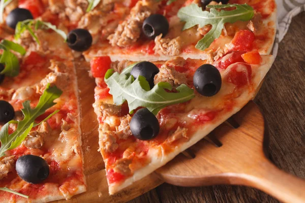 Sliced pizza with tuna macro on a wooden board. Horizontal — Stock Photo, Image