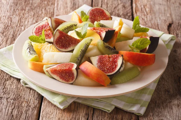 Salad of ripe fruit: figs, peaches, melons, kiwi and orange clos — Stock Photo, Image