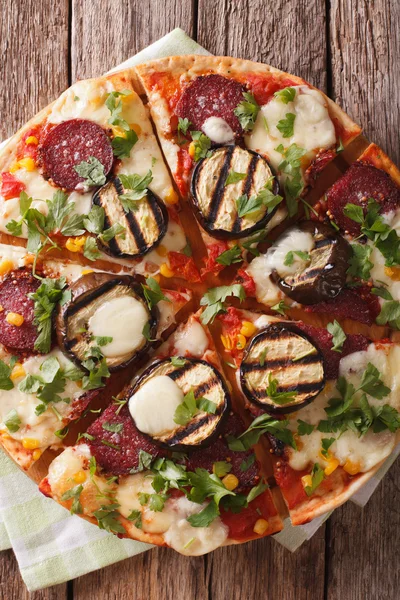 Pizza with eggplant, salami, corn and mozzarella close up. Verti — Stock Photo, Image