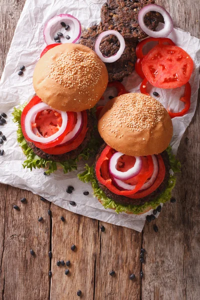 bean veggie burgers with vegetables close-up. Vertical top view