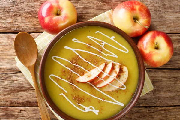 Delicious Austrian apple puree soup with cinnamon close-up in a plate on the table. horizontal top view from abov