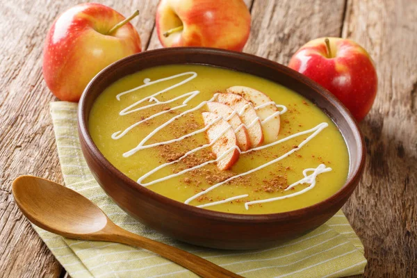Delicious Austrian apple puree soup with cinnamon close-up in a plate on the table. horizonta