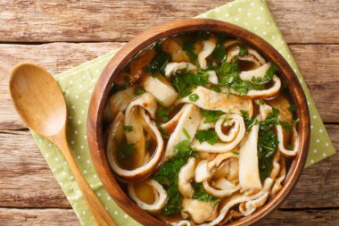 Delicious Austrian and German pancake soup close-up in a plate on the table. horizontal top view from abov