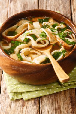 Recipe for Pancake or Crepe Soup Frittaten Suppe close-up in a plate on the table. vertica