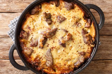 Tave kosi baked lamb and rice with yoghurt close-up in a pan on the table. horizontal top view from abov