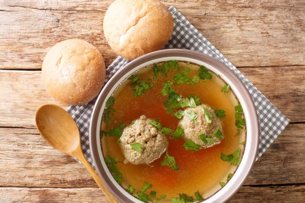Homemade German broth with liver dumplings close-up in a plate on the table. horizontal top view from abov — Stock Image Homemade German Broth Liver Dumplings Close Plate Table Horizontal Top Stock Photo