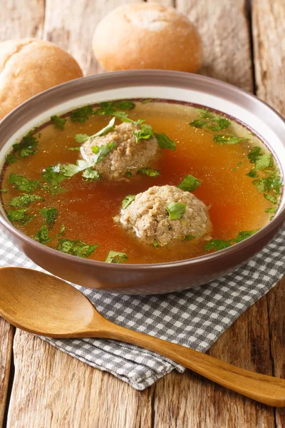 Liver Dumplings are a traditional Bavarian dish severd in a hot brooth close-up in a plate on the table. Vertica — Stock Image Liver Dumplings Traditional Bavarian Dish Severd Hot Brooth Close Plate Stock Picture
