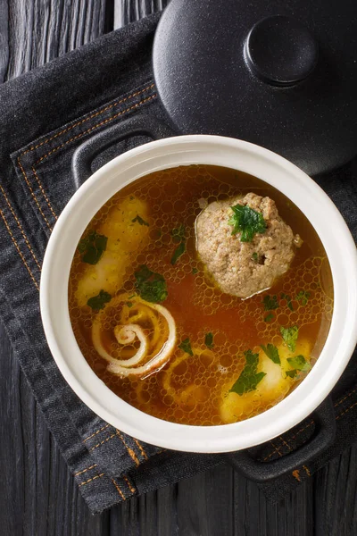 Rindsuppe Brown Beef Soup Recipe close-up in a saucepan on the table. Vertical top view from abov — Stock Image Rindsuppe Brown Beef Soup Recipe Close Saucepan Table Vertical Top Stock Picture