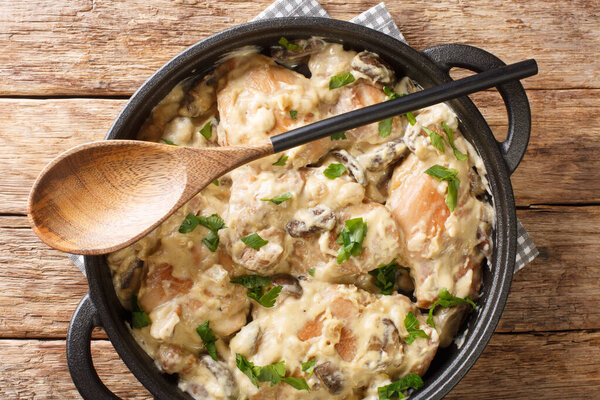 Chicken in White Wine Hong am Reisleck Luxembourg recipe closeup in the pan on the table. horizontal top view from abov