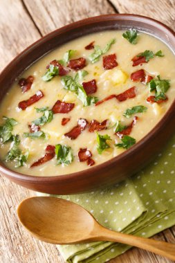 Bezelye ve arpa çorbası ve masada yakın plan domuz pastırması. Dikey