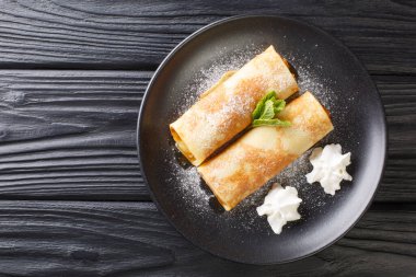Apricot crepes traditional Austrian cuisine close-up in a plate on the table. horizontal top view from abov
