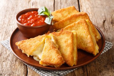 Mozzarella in Carrozza Golden Grilled Cheese Sandwiches closeup in the plate on the table. horizonta clipart