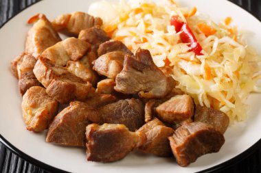 Haiti usulü kızarmış domuz Griot ve masada yakın plan sebze salatası. Yatay