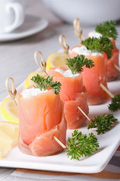 Finger food. Rolls of salmon closeup on the table vertical — Stock Photo, Image