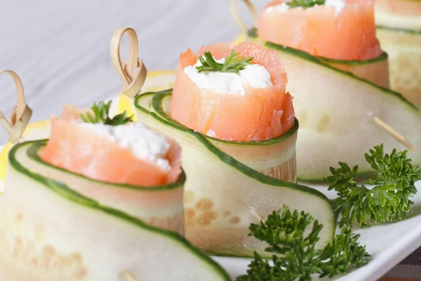 Cucumber rolls with salmon, cream cheese macro horizontal — Stock Photo, Image