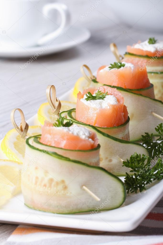 cucumber rolls with salmon, cream cheese closeup vertical 