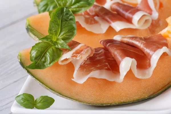 Tasty melon with ham and basil close-up  horizontal — Stock Photo, Image