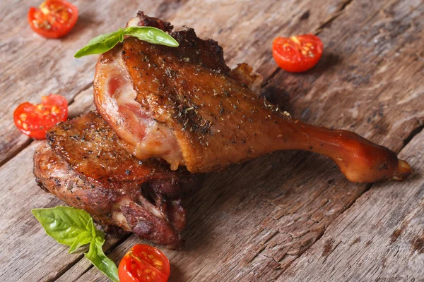 Two fried duck legs and basil, cherry tomatoes closeup on table — Stock Photo, Image