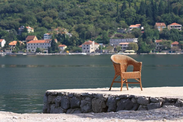 Old wicker chair on the bay. Montenegro — Stock Photo, Image