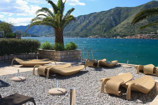 Fabulous beach with wicker loungers on the shore Montenegro — Stock Photo, Image