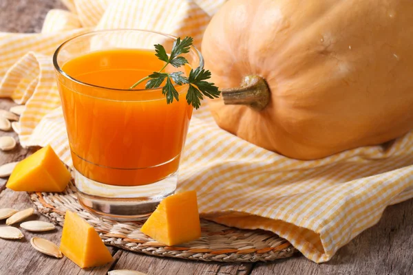 Ein ganzer Kürbis und frischer Saft in Nahaufnahme — Stockfoto