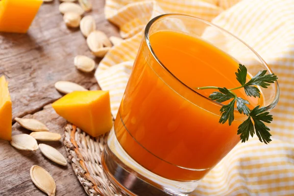 Pumpkin juice with parsley close-up on the table — Stock Photo, Image