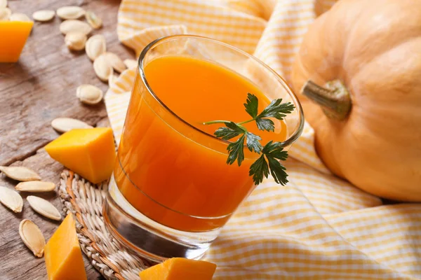 Pumpkin juice with pulp close-up on a table