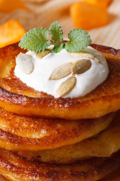 A stack of pumpkin pancakes with sour cream — Stock Photo, Image