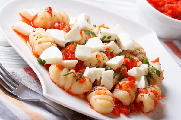 Gnocchi with mozzarella and tomato macro. Horizontal — Stock Photo, Image
