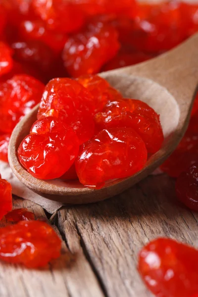 Dried red cherries in a wooden spoon,  vertical — Stock Photo, Image