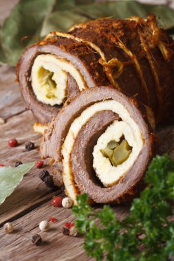 Meat roll stuffed with eggs and cucumber closeup. vertical  clipart