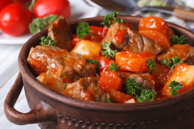 stew in tomato sauce with vegetables close up in a pot clipart