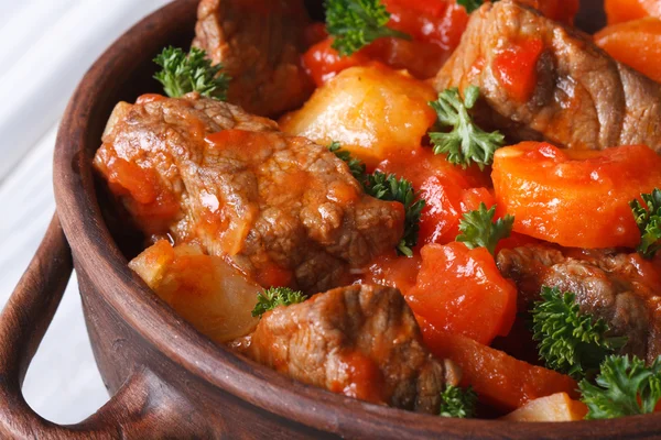 Stew in tomato sauce with vegetables and herbs macro. top view — Stock Image Stew in tomato sauce with vegetables and herbs macro. top view Stock Picture