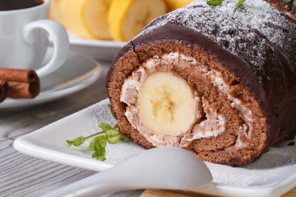 Chocolate roll with a delicate cream and banana closeup — Stock Photo, Image