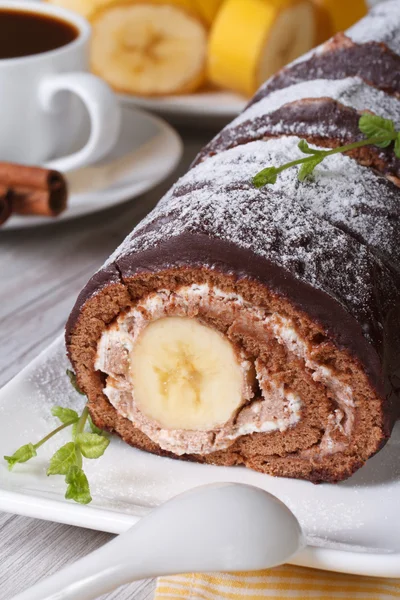 A delicious chocolate banana roll and coffee, closeup — Stock Photo, Image