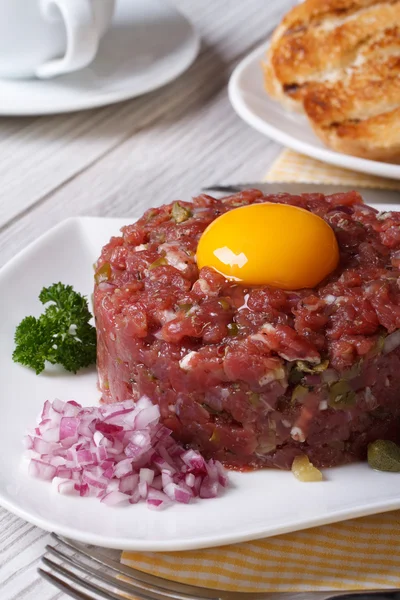 Beef tartare with egg and vegetables closeup.  Vertical — Stock Photo, Image