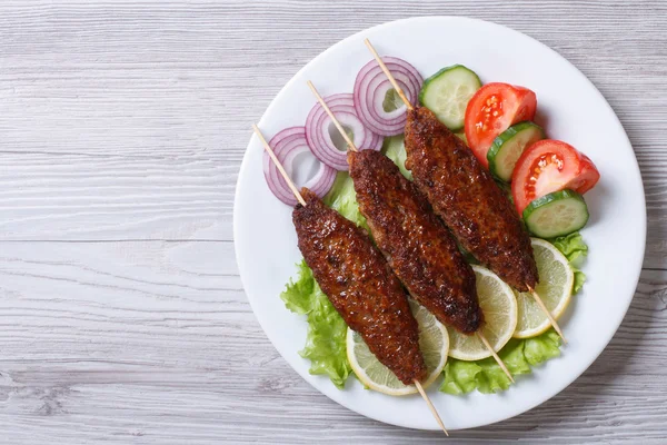 Kebab van gehakt vlees op houten spiesen, bovenaanzicht — Stockfoto