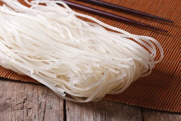 Dry rice noodles with chopsticks close up horizontal — Stock Photo, Image