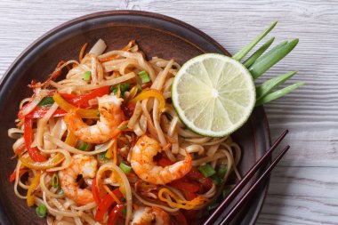 Asian rice noodles with shrimp and vegetables top view