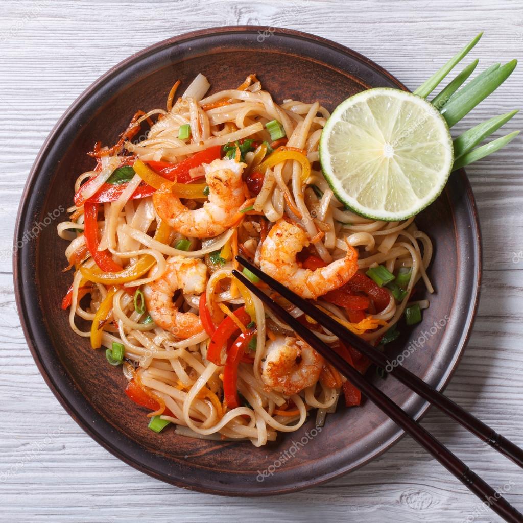 Delicious rice noodles with shrimp and vegetables top view — Stock ...