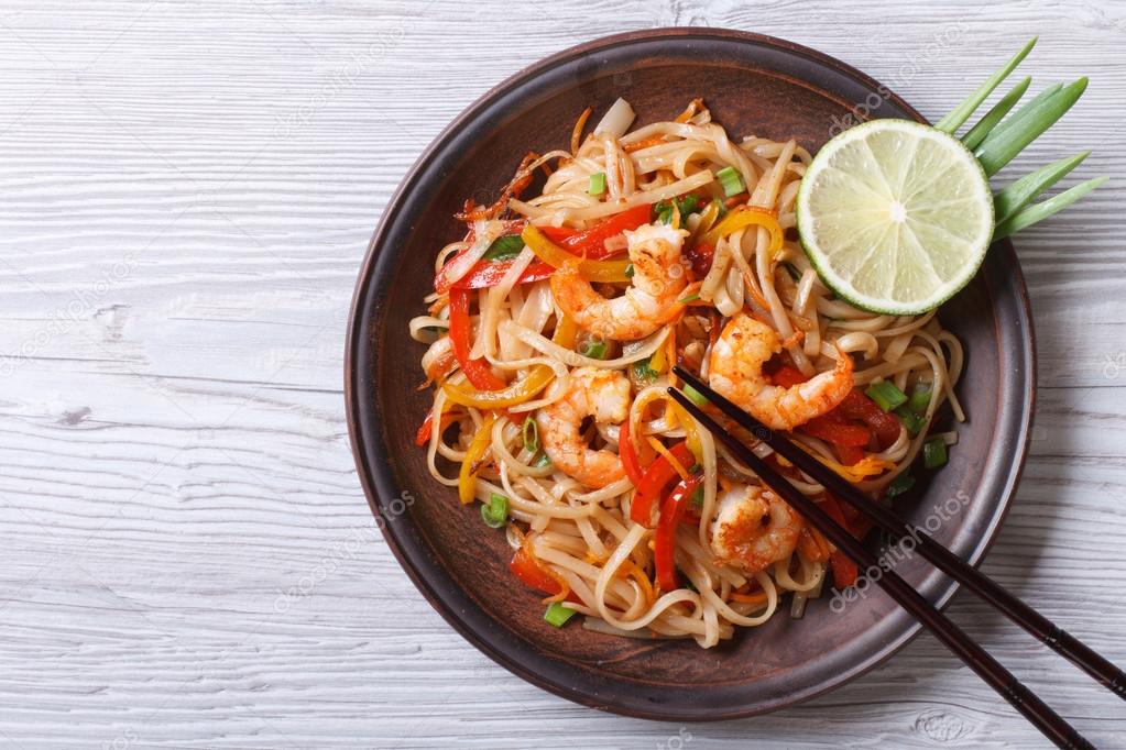 Rice noodles with shrimps and vegetables top view 