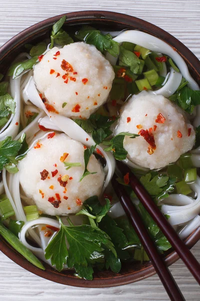 Soup with fish balls and rice noodles closeup. vertical top view — Stock Photo, Image